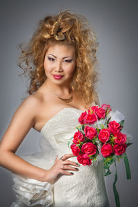 Portrait of a beautiful young woman against white background