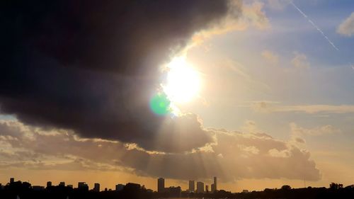 Sunlight streaming through clouds during sunset