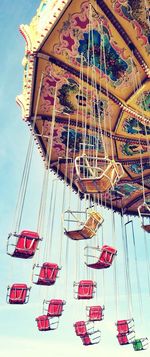 Low angle view of ferris wheel against sky