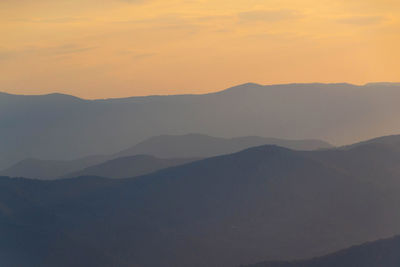 Scenic view of silhouette mountains against sky during sunset