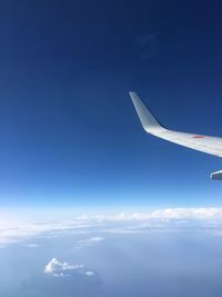 Aerial view of airplane wing against sky