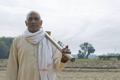 Portrait of indian farmer holding hoe