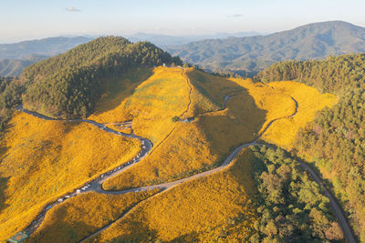 High angle view of land and mountains against sky