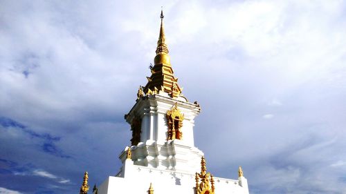 Low angle view of statue against temple against sky