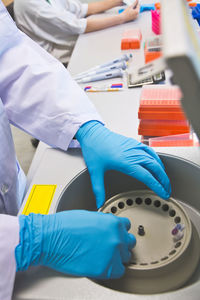 Cropped image of scientists working at laboratory