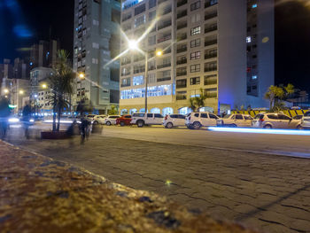 Illuminated city street and buildings at night