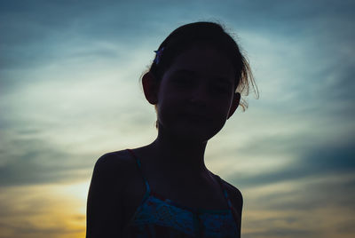 Portrait of girl against sky during sunset