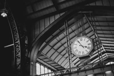 Low angle view of clock on ceiling at railroad station