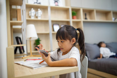 Boy sitting on table