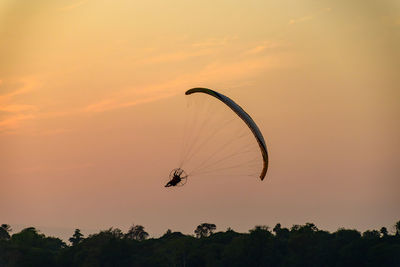 Low angle view of silhouette kite against sky during sunset