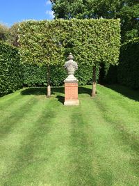 Statue against trees and plants