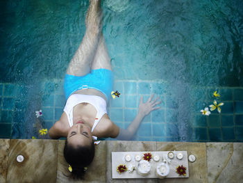 High angle view of young woman relaxing in swimming pool
