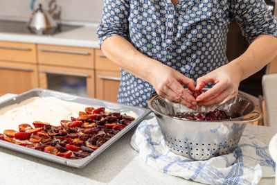 Midsection of man preparing food at home