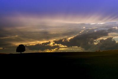 Silhouette landscape against sky during sunset