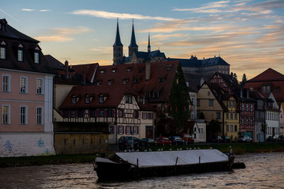 Boats in river with buildings in background