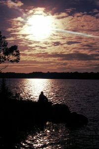 Scenic view of river at sunset