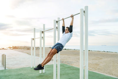 Low section of woman exercising on field