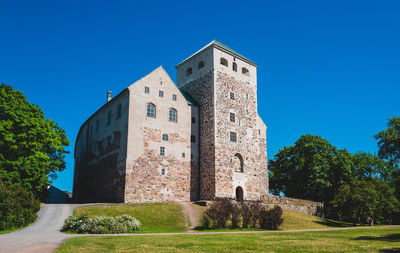 Low angle view of historic building against blue sky