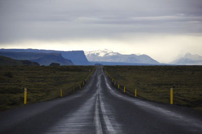 Empty road amidst landscape