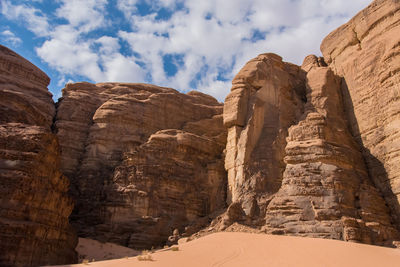 Low angle view of rock formation against sky