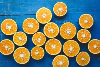 Directly above shot of orange fruit against white background