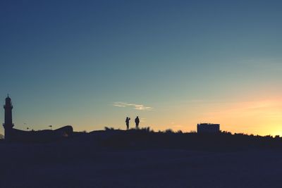 Silhouette landscape against clear sky during sunset