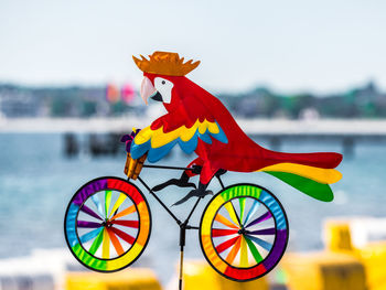 Close-up of multi colored toy on boat against sky