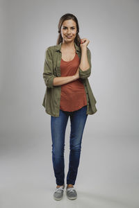 Portrait of a smiling young woman against white background