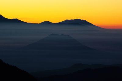 Scenic view of mountains against sky during sunset