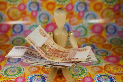High angle view of money with figurine on table