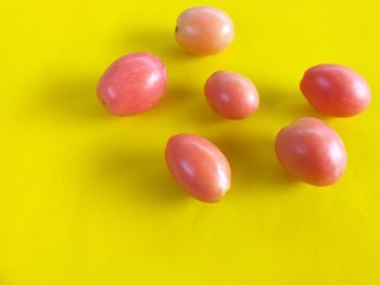 Close-up of grapes against yellow background