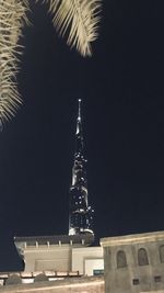 Low angle view of illuminated building against sky at night