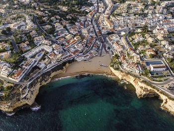 High angle view of sea and buildings in city