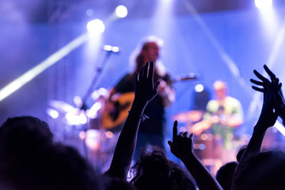 Cropped image of people enjoying at music concert