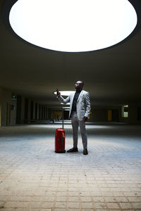 African american traveler with a red suitcase. person