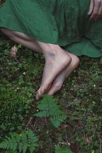 Close up feet on green forest ground concept photo