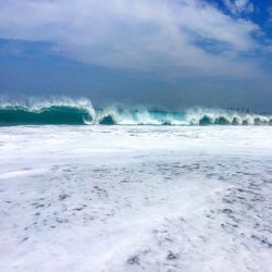 Scenic view of sea against cloudy sky