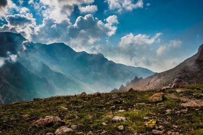 Scenic view of mountains against cloudy sky