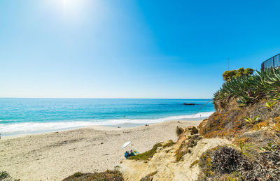 Scenic view of beach against blue sky