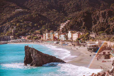 Scenic view of sea by buildings in city