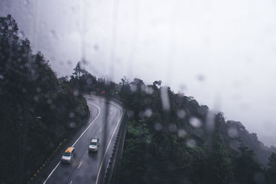 High angle view of cars on road against sky
