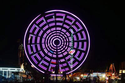 Illuminated ferris wheel at night