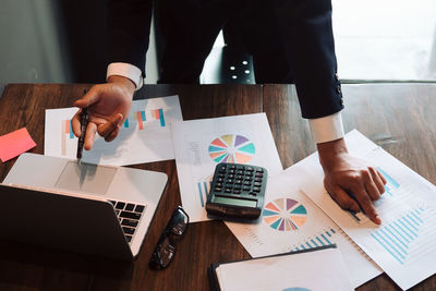 Low angle view of man using laptop on table