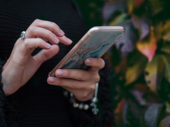 Close-up of woman holding smart phone