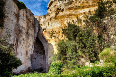 Low angle view of rock formation against sky