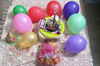 High angle view of multi colored balloons on table