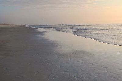 Scenic view of beach against sky during sunset