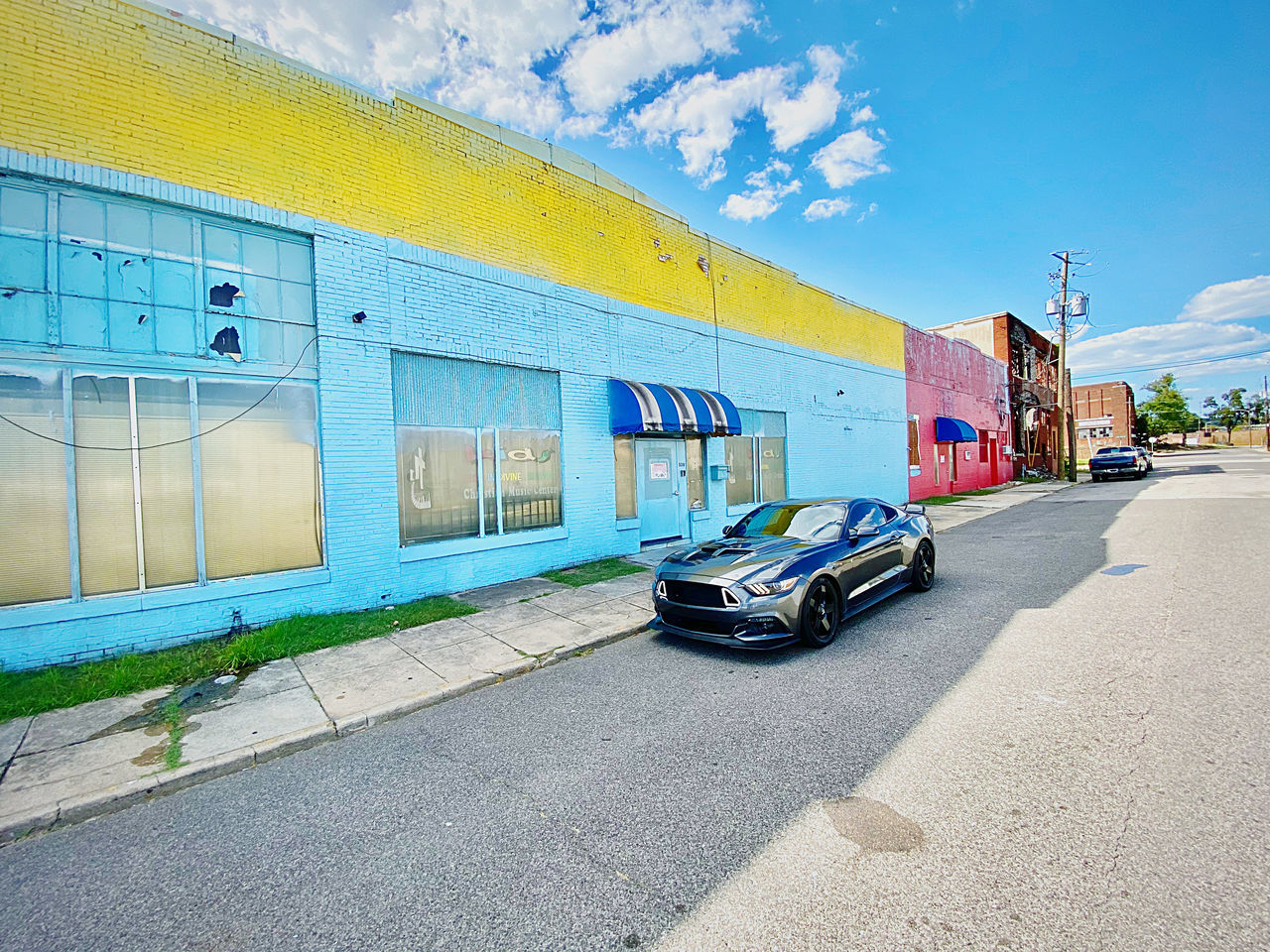 CARS ON STREET AGAINST BUILDINGS