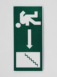 Close-up of arrow sign on white wall