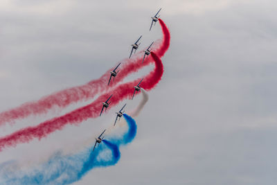 Low angle view of airplane flying against sky